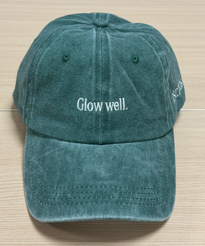 White Glow well lettering on a green Classic Cap