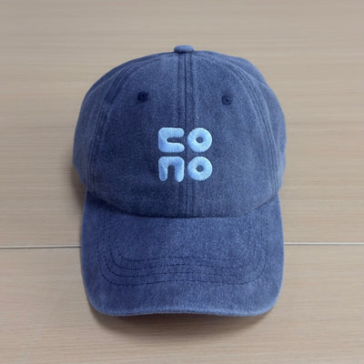 Pale blue raised CONO lettering on a washed navy Classic Cap