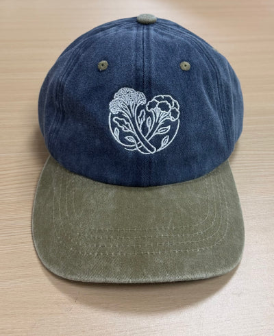 White botanical embroidery on a navy and olive Classic Cap