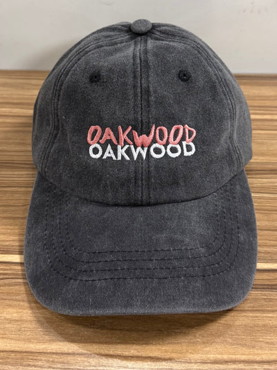 Coral and white Oakwood lettering on a charcoal Classic Cap