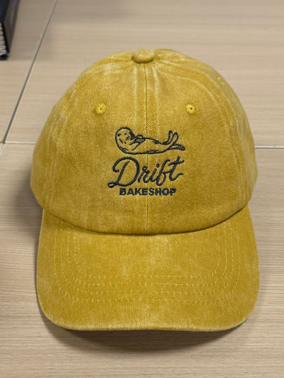 Drift Bakeshop bird embroidery on a mustard Classic Cap