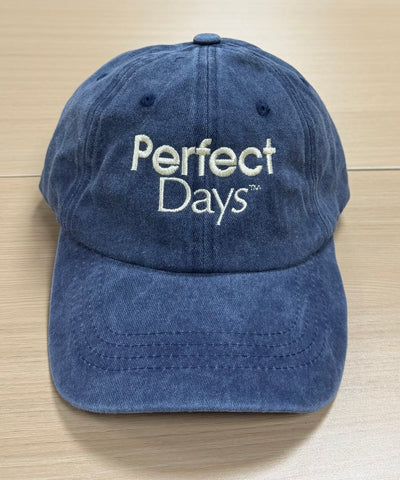 Cream Perfect Days lettering on a washed navy Classic Cap