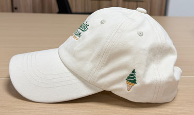 Green ice cream cone embroidery on the side of an off-white Classic Cap