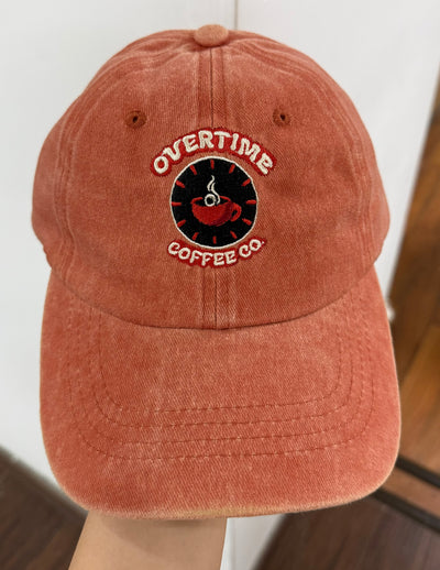 Overtime Coffee emblem on a terracotta Classic Cap