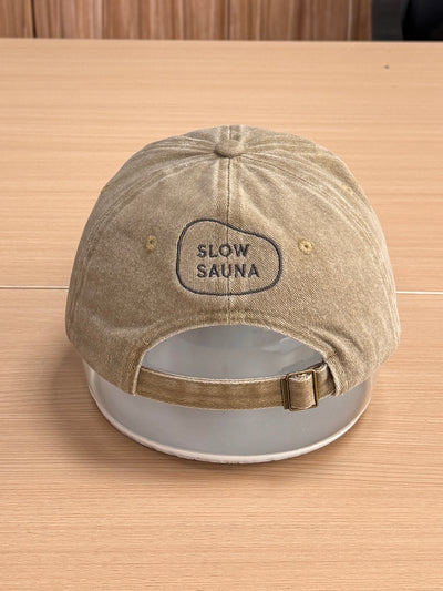 Slow Sauna badge embroidered on the back of a khaki Classic Cap