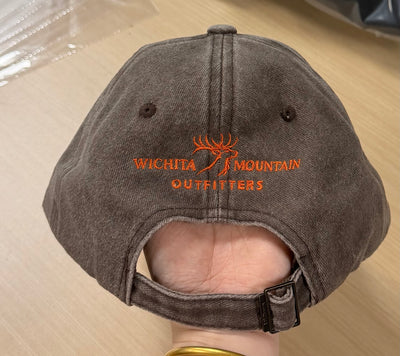Orange Bigtime Montana Outfitters embroidery on the back of a rustic brown Classic Cap