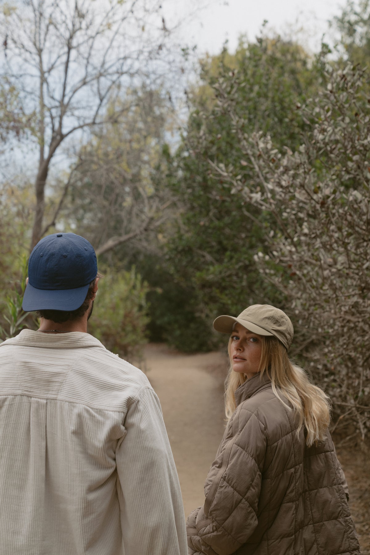 Club Navy and Safari Khaki Ripstop Caps on a wooded path